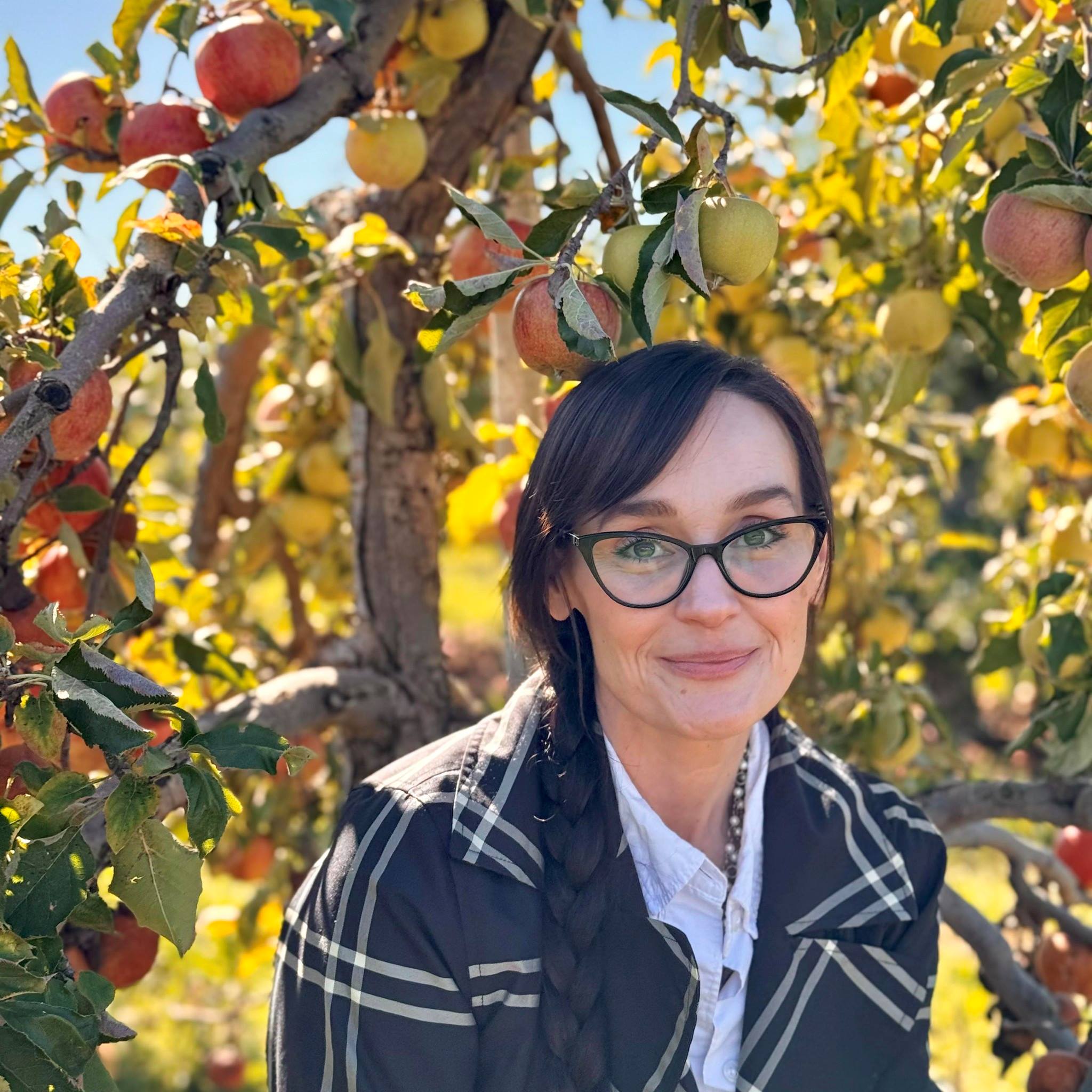 LaDawn Stuben Portrait of the author smiling in front of an apple tree